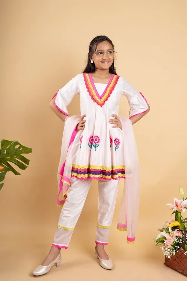 Charming white kurta set with colorful scalloped details and floral embroidery, perfect for festive occasions